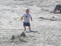 Timothy investigates a sand castle