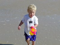 Timothy pours water into the sea