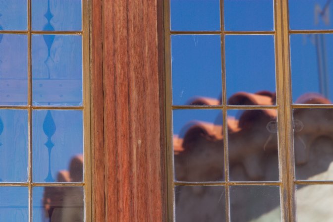 Scotty's Castle reflected in one of its windows