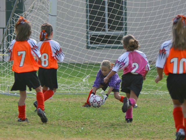 The Tiger goalie Courtney catches a shot from Chandler