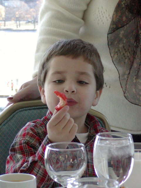 Tommy with a strawberry