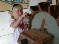 Sara investigates the water wheel exhibit