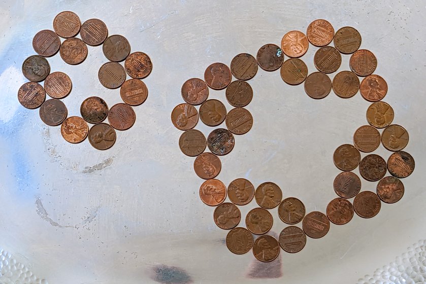 Two three-regular penny graphs, with vertices represented by pennies and edges represented by touching pennies