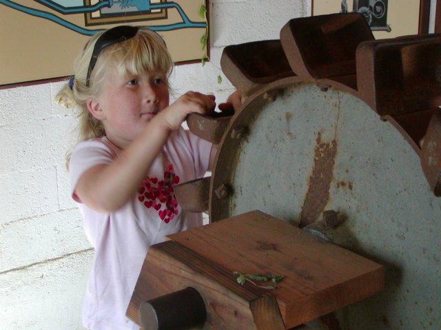 Sara investigates the water wheel exhibit