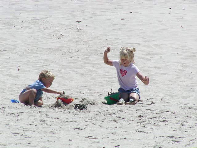 Timothy and Sara play with sand toys