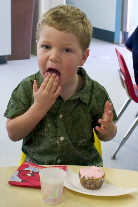 Timothy eats a cupcake