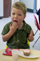 Timothy eats a cupcake