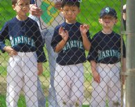 Isaiah, Brian, and Jacob wait for their turns at bat