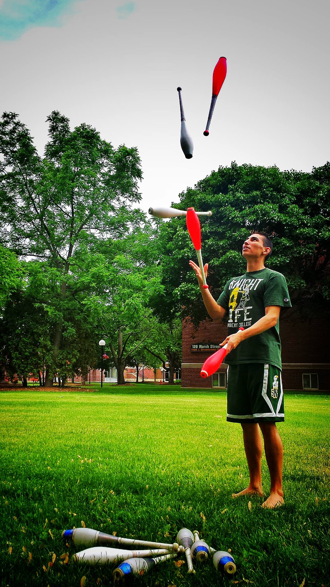 Kyle juggling 5 clubs in an open quad.  PC: Casey Rentmeester